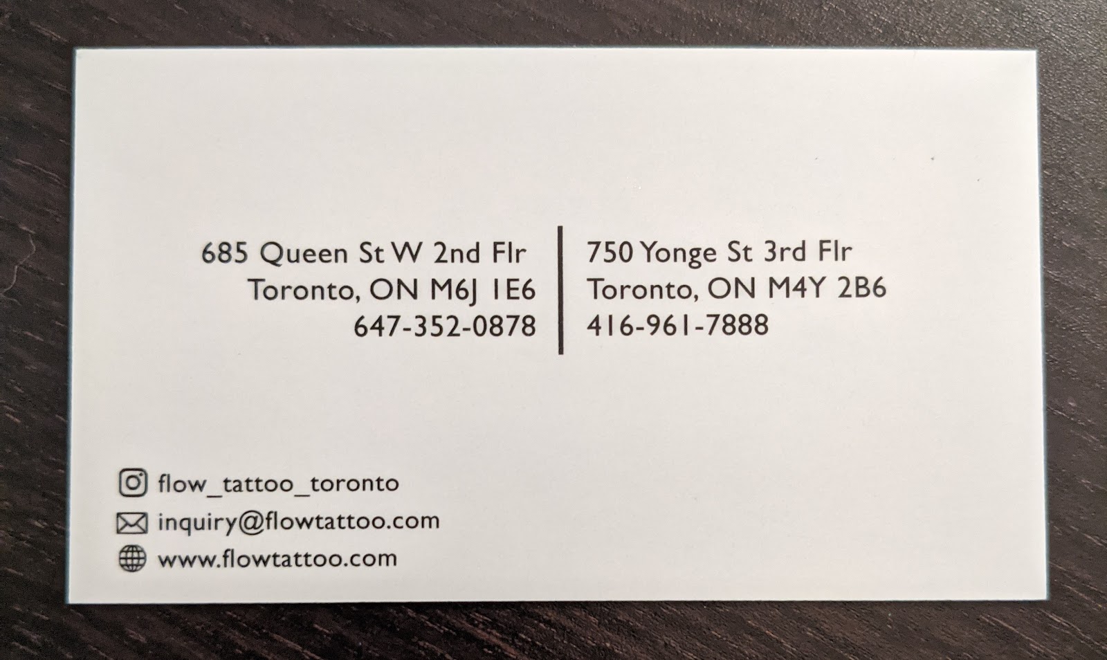 Back of the business card showing the 685 Queen St W address and phone number